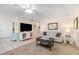Bright living room featuring comfy seating, a large TV, and a coffee table at 6300 Midnight Pass Rd # 20, Sarasota, FL 34242