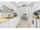 Well-equipped kitchen with white cabinets and stainless steel appliances at 6300 Midnight Pass Rd # 20, Sarasota, FL 34242