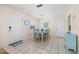 Bright dining area with a table and chairs, near entryway at 6300 Midnight Pass Rd # 20, Sarasota, FL 34242