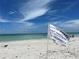 White sand beach with ocean and blue sky at 6300 Midnight Pass Rd # 20, Sarasota, FL 34242