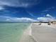 Relaxing beach scene with calm water and blue sky at 6300 Midnight Pass Rd # 20, Sarasota, FL 34242