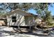 Charming single-story home with a deck, front stairs, concrete pier foundation, and light beige siding at 202 Patterson Ave, Osprey, FL 34229