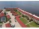 Aerial view showing building, parking, pool, and waterfront location at 1 Colony Point Dr # 5C, Punta Gorda, FL 33950