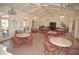 Community clubhouse with tables, chairs, and a TV at 1 Colony Point Dr # 5C, Punta Gorda, FL 33950