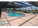 Community pool with screened enclosure and lounge chairs at 1 Colony Point Dr # 5C, Punta Gorda, FL 33950