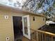 View of house with newly installed exterior door and small deck at 206 Patterson Ave, Osprey, FL 34229