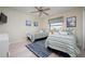 Guest bedroom with twin beds, ceiling fan, and nautical decor at 2505 Rio Tiber Dr, Punta Gorda, FL 33950