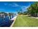 Spacious backyard with canal access, lush landscaping, and a covered patio at 2505 Rio Tiber Dr, Punta Gorda, FL 33950