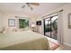 Main bedroom with a king-size bed and sliding doors to a screened patio at 2505 Rio Tiber Dr, Punta Gorda, FL 33950