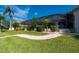 Landscaped backyard featuring a brick path and a screened pool area at 2505 Rio Tiber Dr, Punta Gorda, FL 33950