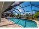 Enclosed pool area with waterfront views featuring a screened lanai and tile flooring at 2505 Rio Tiber Dr, Punta Gorda, FL 33950