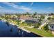 Aerial view of waterfront home with pool, dock, and lush landscaping at 2505 Rio Tiber Dr, Punta Gorda, FL 33950
