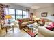 Living room with hardwood floors, large windows and sofa set at 234 Fields Se Ter, Port Charlotte, FL 33952