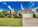 Single-story home with tile roof, attached garage, and nicely landscaped yard at 234 Fields Se Ter, Port Charlotte, FL 33952