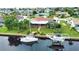 Aerial view of canal-front home with lush landscaping and boat at 234 Fields Se Ter, Port Charlotte, FL 33952