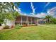 Spacious backyard with a screened lanai and lush landscaping at 234 Fields Se Ter, Port Charlotte, FL 33952
