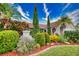 Landscaped front yard with colorful flowers and lush greenery at 234 Fields Se Ter, Port Charlotte, FL 33952