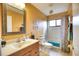 Bathroom with shower/tub combo, wood vanity, and updated fixtures at 234 Fields Se Ter, Port Charlotte, FL 33952