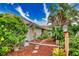 Landscaped side yard with a stone path and lush tropical plants at 234 Fields Se Ter, Port Charlotte, FL 33952