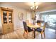 Bright dining area with a round table, four chairs, and a wooden hutch at 234 Fields Se Ter, Port Charlotte, FL 33952