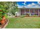 Landscaped backyard with a screened porch and lush greenery at 234 Fields Se Ter, Port Charlotte, FL 33952