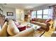 Bright living room features comfortable sofas and a coffee table, creating a welcoming atmosphere at 234 Fields Se Ter, Port Charlotte, FL 33952
