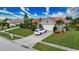 Single-Gathering home with a two-car garage and lush landscaping at 234 Fields Se Ter, Port Charlotte, FL 33952