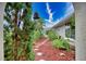 Landscaped walkway with stepping stones and lush greenery at 234 Fields Se Ter, Port Charlotte, FL 33952