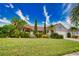 Single-story home with tile roof, attached garage, and lush landscaping at 234 Fields Se Ter, Port Charlotte, FL 33952