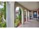 Covered entryway with arched walkway and tile flooring at 234 Fields Se Ter, Port Charlotte, FL 33952