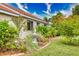 Landscaped side yard with fountain and tropical plants at 234 Fields Se Ter, Port Charlotte, FL 33952