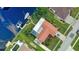 Aerial view of house, pool, boat dock, and lush landscaping at 234 Fields Se Ter, Port Charlotte, FL 33952
