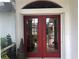 Red double front doors with a decorative glass panes at 431 San Felix St, Punta Gorda, FL 33983