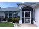 Front entrance with a red door, white columns, and landscaping at 431 San Felix St, Punta Gorda, FL 33983