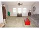 Spacious living room with gray sofa, red trunk coffee table, and large windows at 431 San Felix St, Punta Gorda, FL 33983