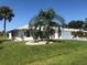 House with palm trees, green lawn, and a white and gray exterior at 431 San Felix St, Punta Gorda, FL 33983