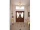 Bright and spacious entryway with double doors and tile flooring at 1307 Tidy Ln, Punta Gorda, FL 33983