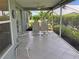 Enjoy this screened porch with seating and a view of the garden at 1307 Tidy Ln, Punta Gorda, FL 33983
