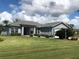One story home with light blue exterior, two car garage and nicely landscaped yard at 1307 Tidy Ln, Punta Gorda, FL 33983