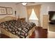 Bright bedroom with double bed, wicker furniture, and wood floors at 1307 Tidy Ln, Punta Gorda, FL 33983