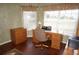 Spacious home office with wood desk, built-in shelving, and hardwood floors at 1307 Tidy Ln, Punta Gorda, FL 33983