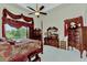 Main bedroom with a four-poster bed and large windows at 8430 Acorn Blvd, Punta Gorda, FL 33982