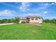 House exterior with a large backyard and mature landscaping at 8430 Acorn Blvd, Punta Gorda, FL 33982