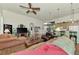 Spacious living room with hardwood floors, comfortable seating, and a large TV at 8430 Acorn Blvd, Punta Gorda, FL 33982
