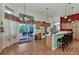 Open kitchen with island, breakfast bar, and access to patio at 8430 Acorn Blvd, Punta Gorda, FL 33982
