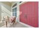 Front porch with seating area and red double doors at 8430 Acorn Blvd, Punta Gorda, FL 33982