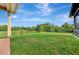 Large grassy backyard with fenced perimeter, providing ample space for outdoor activities at 8430 Acorn Blvd, Punta Gorda, FL 33982