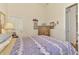 Well-lit bedroom with a dresser, charming artwork, and a comfortable bed at 8430 Acorn Blvd, Punta Gorda, FL 33982