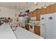 Bright kitchen with white appliances, wood cabinets, and access to backyard at 8430 Acorn Blvd, Punta Gorda, FL 33982