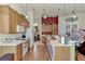 Open kitchen with wood cabinets, island, and view to living room at 8430 Acorn Blvd, Punta Gorda, FL 33982